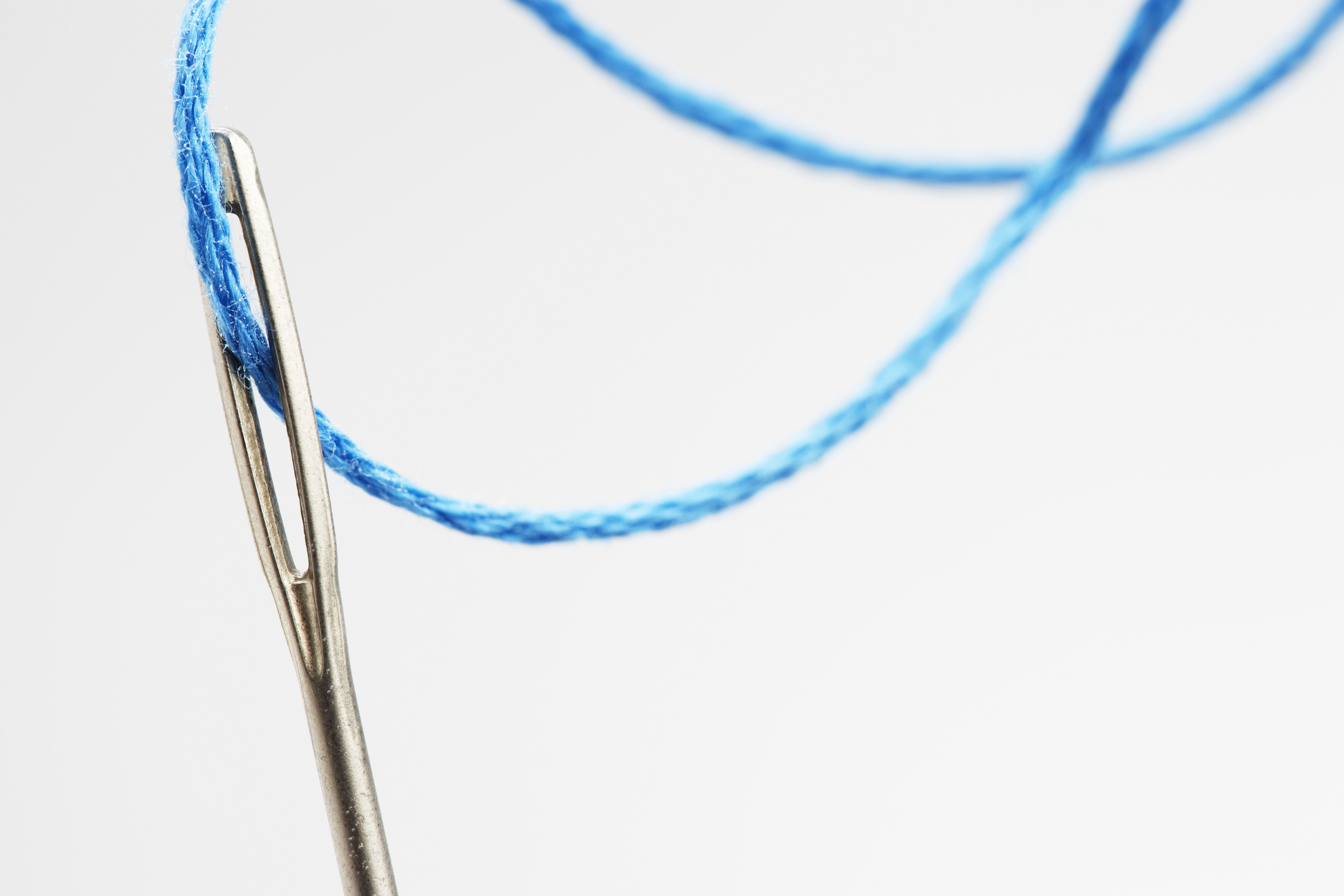 blue thread going through needle eye close up 82633877 5808d5e33df78cbc288127bf